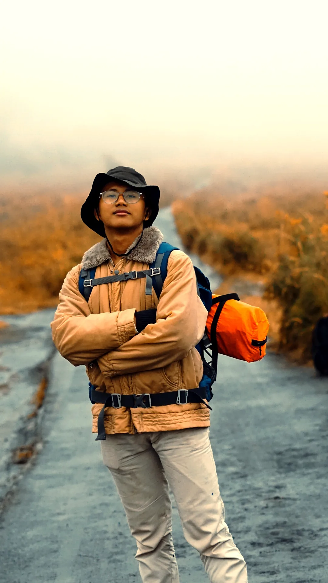 Traveller standing with folded arms against the misty volcanic landscape of Bromo