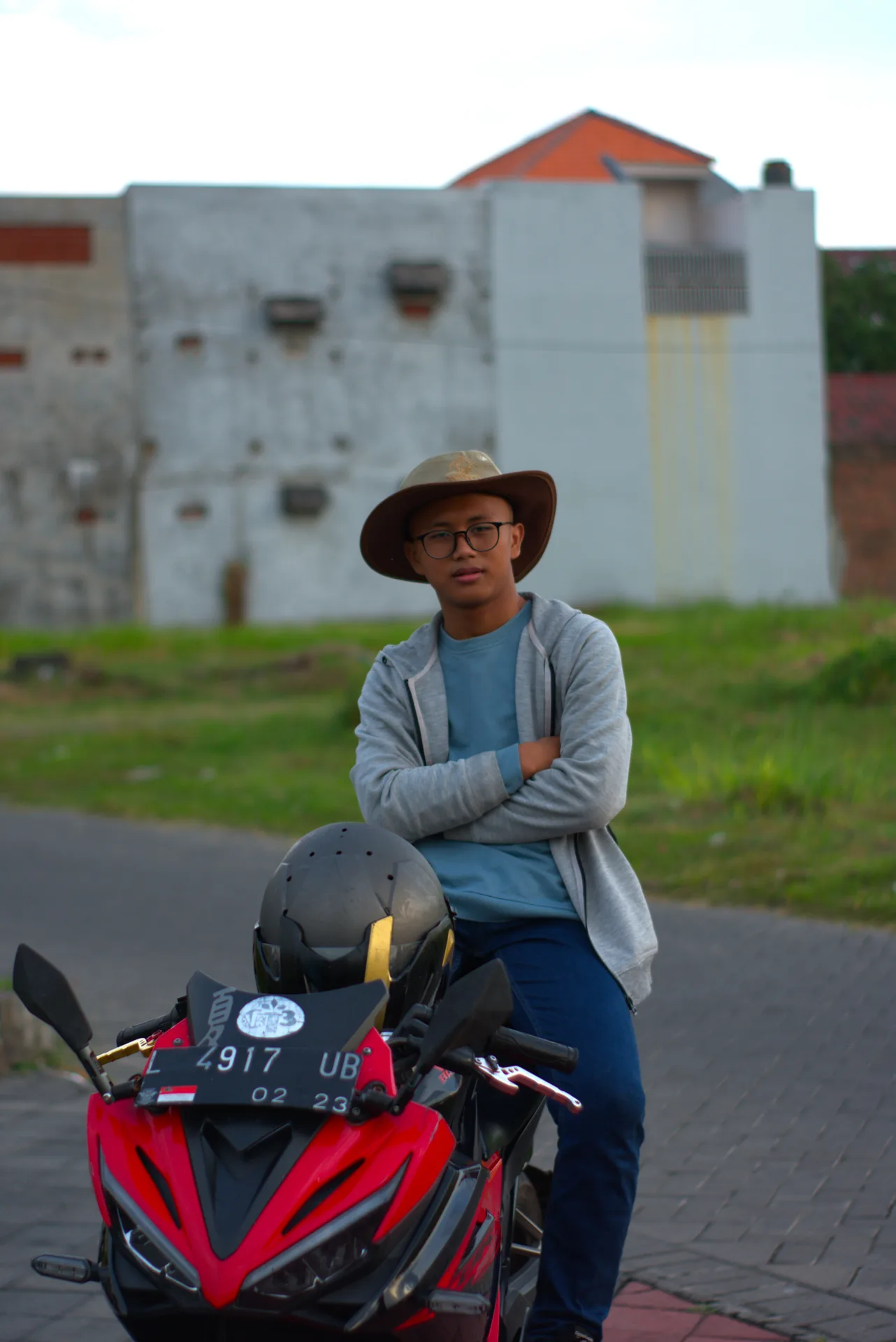 Rider in a wide-brim hat seated on a red CBR motorcycle at GKB Convex